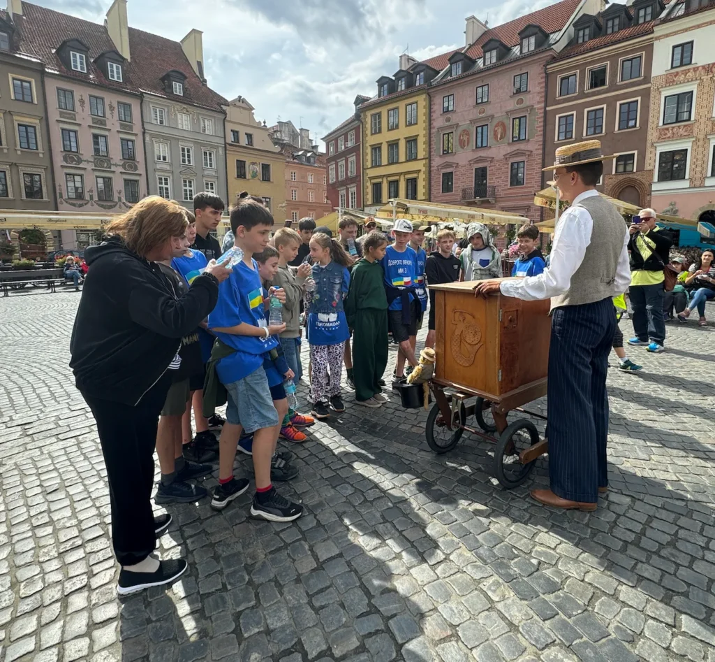 Warsaw Old Town and group of children with guide tour